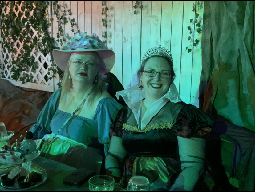 Seated guests dressed as the Queen of Hearts & Alice