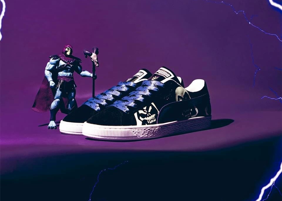 PUMA's Skeletor sneakers posed on a purple background with a figure of the character standing next to them